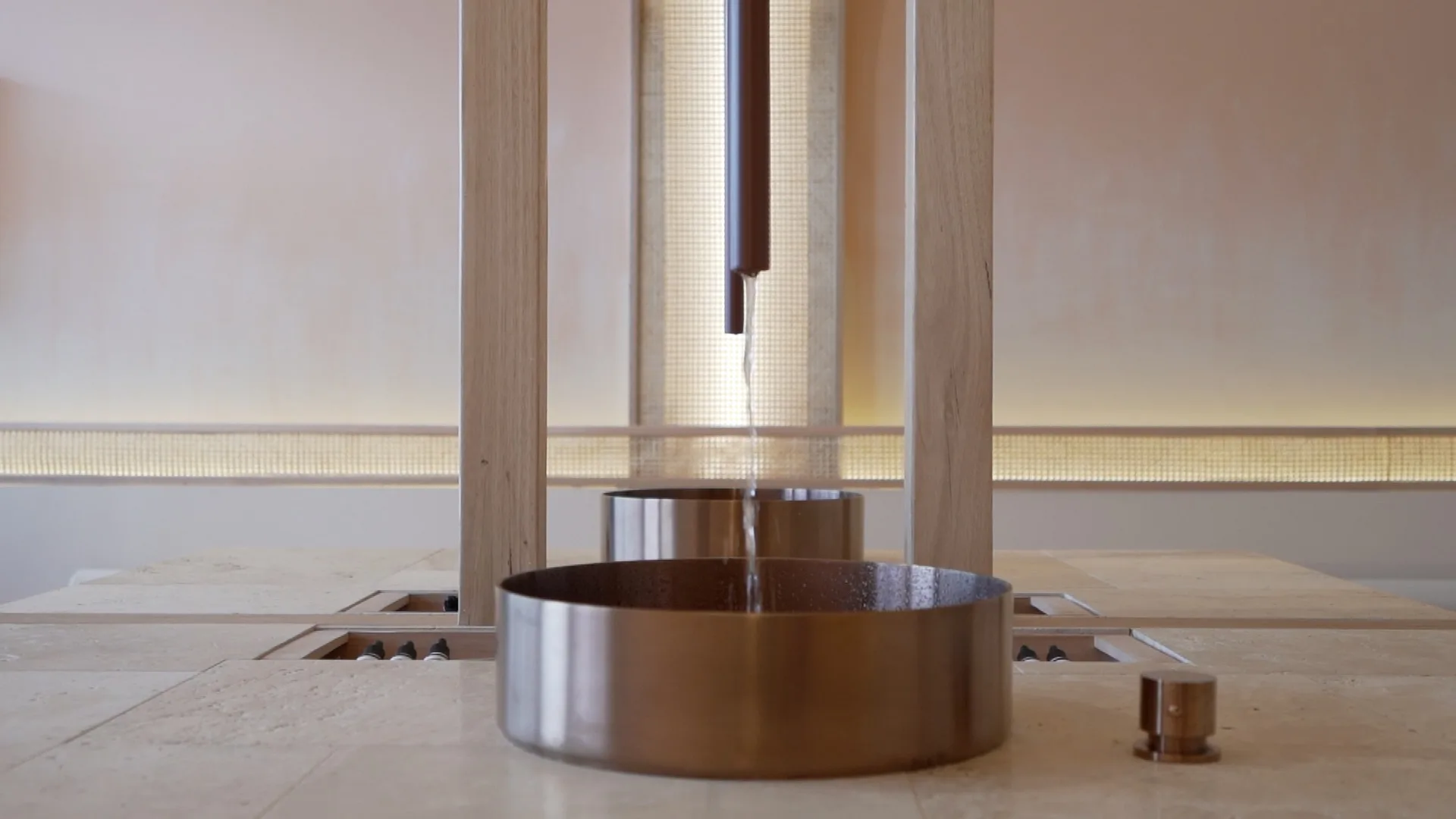 Aesthetik clinic interior — travertine island with copper basin